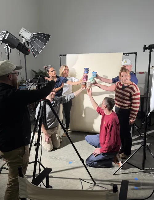 The team toasting on set during a product shoot