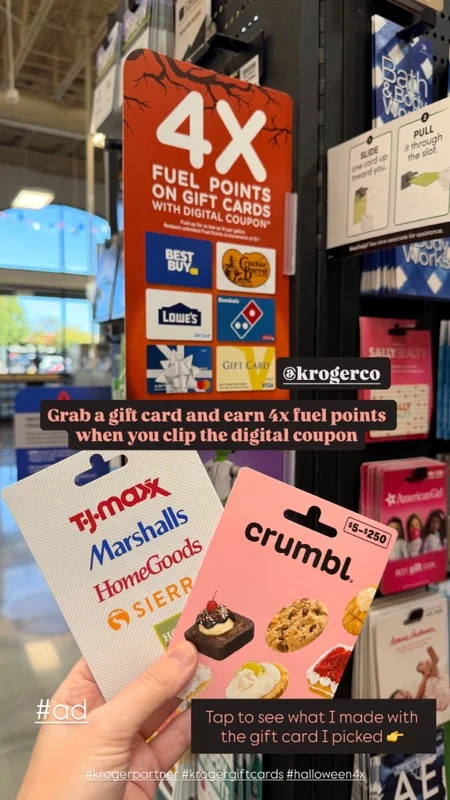 Creator holding T.J. Maxx and Crumbl gift cards beside a 4X Fuel Points on gift cards sign in the aisle