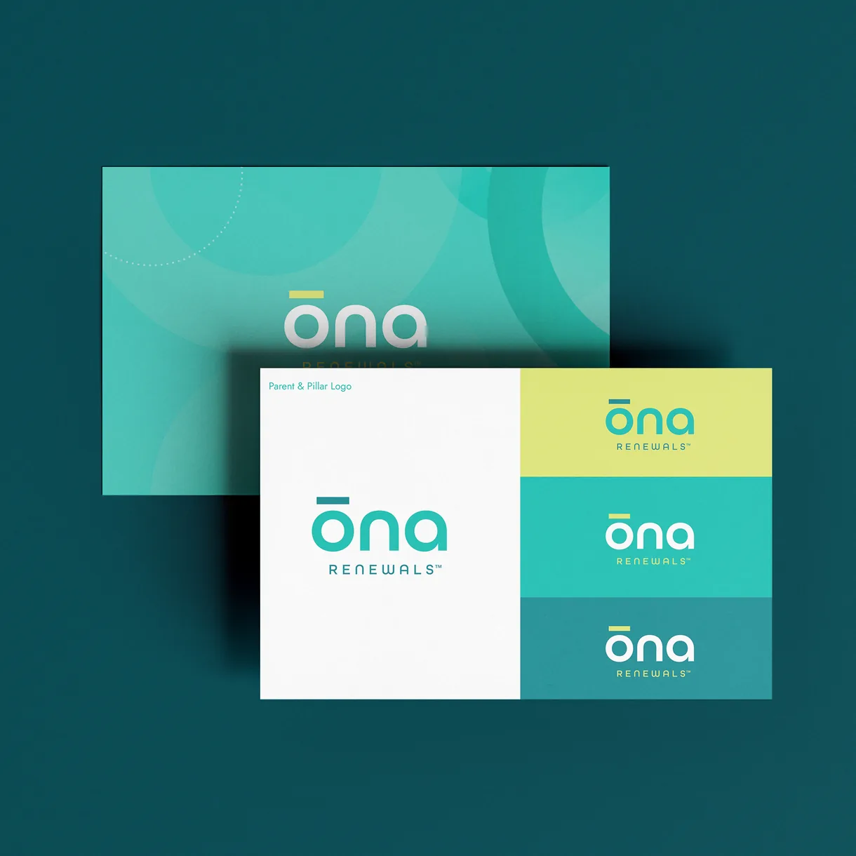 ōna Renewals business cards in teal, yellow, and white on a dark teal surface