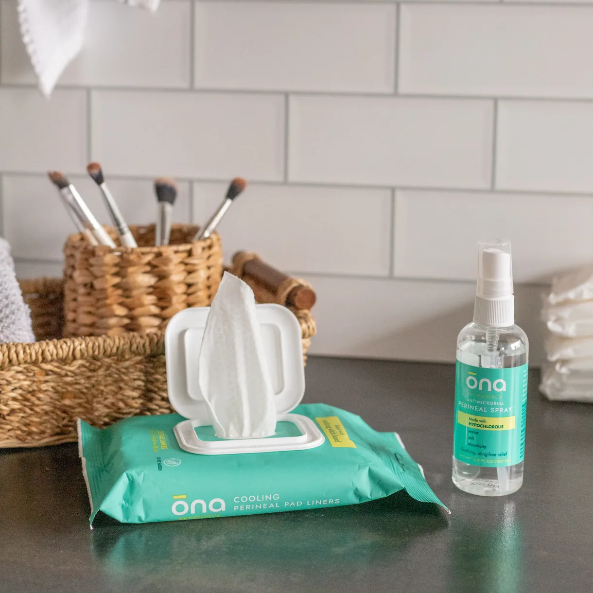 ōna wipes pack and spray bottle on a bathroom counter